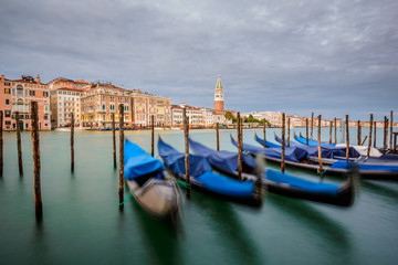 Venetian gondolas on the Grand Canal and St Marks Tower in background, long time exposure, Venice (Venezia), Italy, Europe
