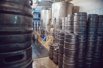Naklejka na ściany i meble Metal beer kegs stand in beer plant. Brewery.