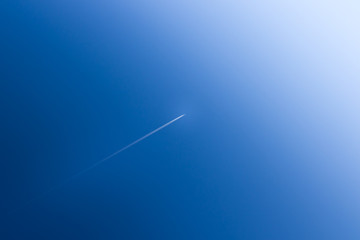 Fototapeta premium Airplane soars into the blue sky