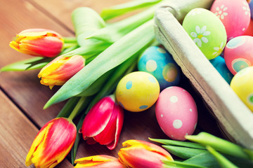 close up of colored easter eggs and flowers