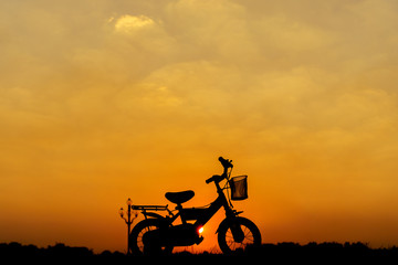 children's bikes silhouette at sunset
