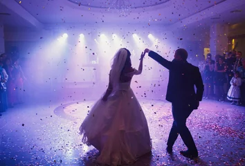 Fotobehang Happy beautiful newlyweds dancing in the restaurant © myronovychoksana