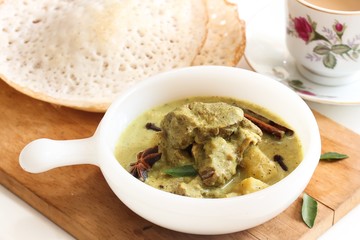 Mutton stew served with Appam - Traditional Kerala Breakfast, selective focus
