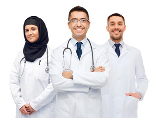Fototapeta premium happy doctors in white coats with stethoscopes