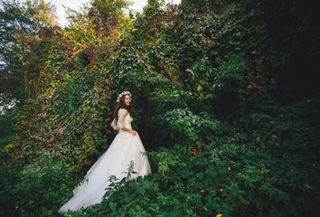 Happy bride among the wild grape