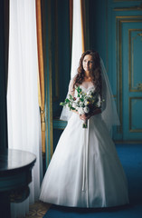 Fototapeta na wymiar Portrait of the lovely bride in the blue room