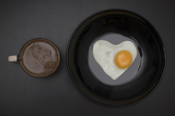 Breakfast on Valentine's Day-fried egg in the shape of a heart,coffee.