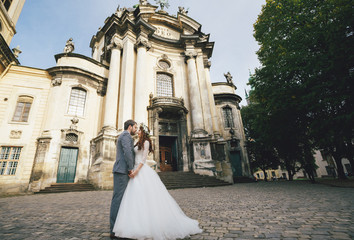 Lovely couple next to the old church in Lviv