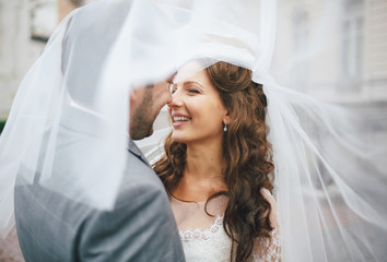 Sincere smile of the bride next to a groom