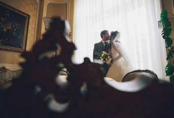 Kiss of the newlyweds in the ancient castle