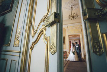 Newlyweds are walking in the luxury castle