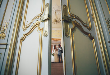 Door with the golden frames and newlyweds behind