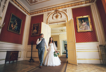 Newlyweds in the luxury red room with the pictures