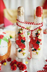 White decorated bottles of champagne on the wedding celebration