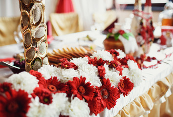 Red and white flowers in the bouquet on the table