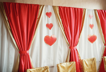 Curtains and the hearts as a decoration of the newlyweds' table