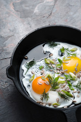 Scrambled eggs  on the dark stone background vertical
