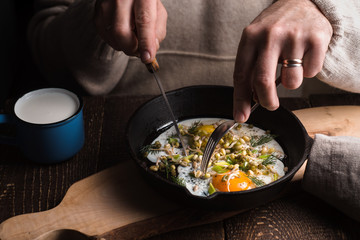 Eating scramble eggs on the wooden table horizontal