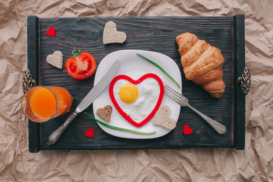 valentine day.romantic breakfast. fruits ,coffee and cookies on shate board 