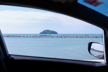 Ocean view through the window of car, Thailand.