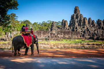 Tourists on an ride elephant tour of Bayon temple in Angkor Thom,landmark in Siem Reap, Cambodia. Angkor wat inscribed on the UNESCO World Heritage List in 1992