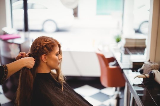 Female hairdresser styling clients hair