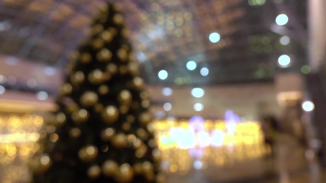 Blurred decorated Christmas and New Year tree at the shopping mall