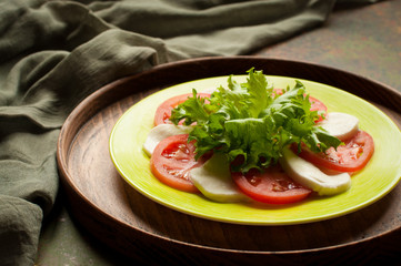 Caprese salad with tomatoes mozzarella, greens
