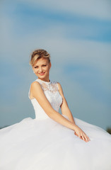 Fototapeta na wymiar Blue sky and a charming bride