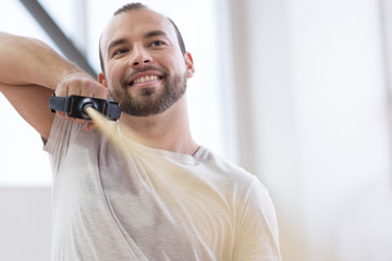 Delighted young handicapped stretching the cable in the gym