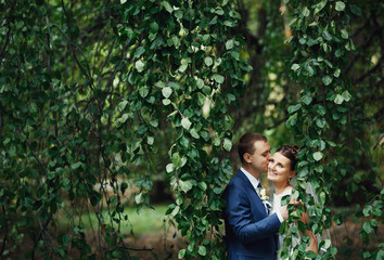 Fototapeta na wymiar happy man kissing his bride on the cheek