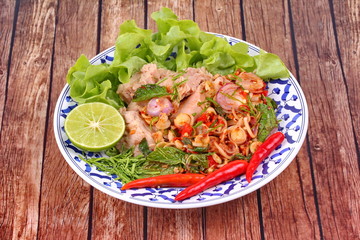 Spicy and sour mixed herb salad with tuna served .