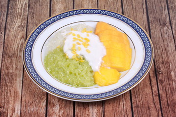 Ripe golden mango with green and white of sticky rice.