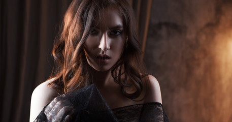 Mysterious portrait of beautiful woman in black lace veil