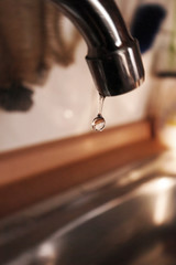 Water drop falling from a tap