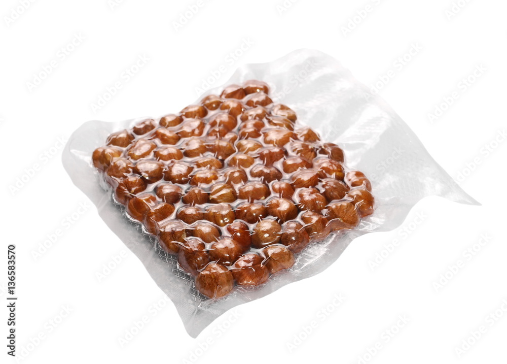 Wall mural hazelnut packed in transparent plastic bag isolated on white background