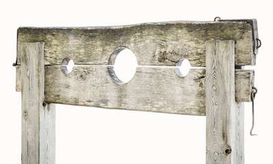 Wooden medieval pillory on white