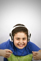 The boy is listening music with headphone