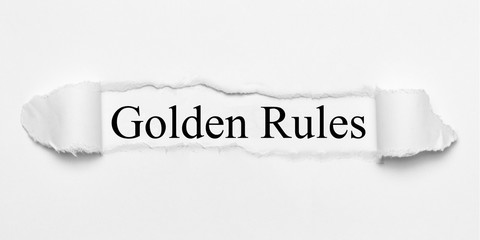 Golden Rules on white torn paper
