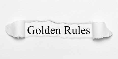 Golden Rules on white torn paper