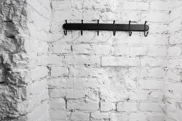 hanger bracket on the background of the painted brick wall