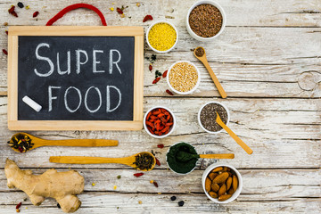 Organic superfood and healthy food on wooden background. 
