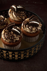 Delicious Oreo cupcakes on dark background. selective focus