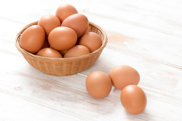 Brown Chicken Eggs in Basket and on Wooden Surface