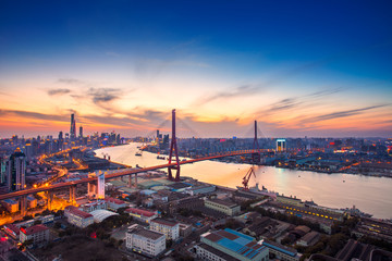 Aerial view of modern bridge at sunset in Shanghai