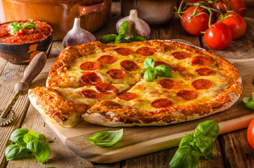 Homemade cheese pizza with salami