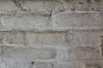 Old plastered white brick wall