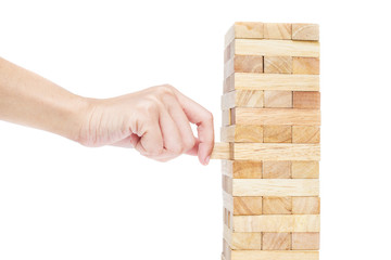 Hand playing with the wood game (jenga). isolate on white backgr