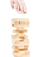 Hand playing with the wood game (jenga). isolate on white backgr