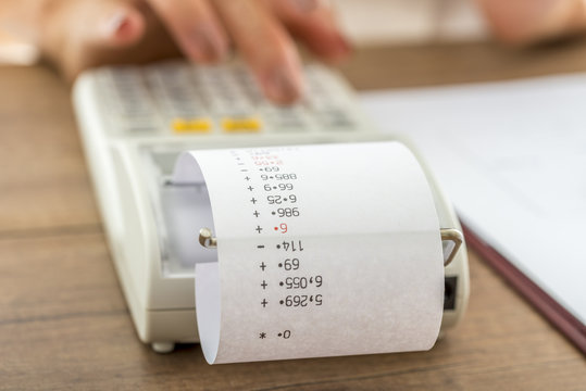 Woman using a manual adding machine